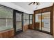 Bright Florida room with wood paneled walls and sliding door to kitchen at 101 Grand Plaza Dr # A40, Orange City, FL 32763