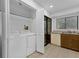 Functional laundry space with washer, dryer, and storage shelves next to the kitchen at 101 Grand Plaza Dr # A40, Orange City, FL 32763