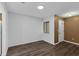 Bright living room with new hardwood floors, fresh white paint, and a front door at 101 Grand Plaza Dr # A40, Orange City, FL 32763