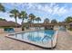 Community pool area surrounded by palm trees and lounge chairs at 101 Grand Plaza Dr # A40, Orange City, FL 32763