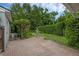 Backyard with brick patio, lush greenery, and decorative statue for relaxation at 1021 N Forest Ave, Orlando, FL 32803