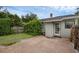 Backyard with lush landscaping, a brick patio, and an exterior door at 1021 N Forest Ave, Orlando, FL 32803