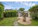 Backyard featuring greenery, brick patio with a decorative statue, and serene ambiance at 1021 N Forest Ave, Orlando, FL 32803