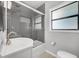 Modern bathroom featuring gray tile, a shower/tub combo, and a sleek vanity at 1021 N Forest Ave, Orlando, FL 32803