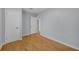 This bright bedroom features neutral walls and wood-look floors at 1021 N Forest Ave, Orlando, FL 32803