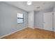 Clean bedroom features wood floors, neutral wall color, and a window at 1021 N Forest Ave, Orlando, FL 32803