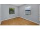 This cozy bedroom features wood floors, neutral walls, and two large windows at 1021 N Forest Ave, Orlando, FL 32803