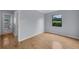 Bright bedroom features hardwood floors and a window offering natural light at 1021 N Forest Ave, Orlando, FL 32803