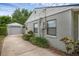 Home exterior with a detached garage, long driveway, and well-maintained landscaping at 1021 N Forest Ave, Orlando, FL 32803