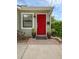 Close-up of the red front door with potted plants and brick walkway adding a touch of elegance at 1021 N Forest Ave, Orlando, FL 32803