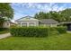 Charming home with lush front yard and neatly trimmed hedges enhancing curb appeal at 1021 N Forest Ave, Orlando, FL 32803