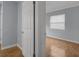 Hallway leading to a bedroom with hardwood floors and neutral wall colors at 1021 N Forest Ave, Orlando, FL 32803