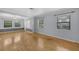 Bright and airy living room with hardwood floors and large windows offering plenty of natural light at 1021 N Forest Ave, Orlando, FL 32803
