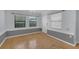 Living room with three windows bringing in natural light and hardwood floors at 1021 N Forest Ave, Orlando, FL 32803