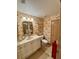 Charming powder room featuring a marble vanity, decorative wallpaper, and stylish fixtures at 10350 Lake District Ln # S, Orlando, FL 32832