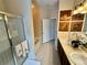 Bright bathroom boasts double sinks, soaking tub, glass shower, and wood-framed decorative art at 10350 Lake District Ln # S, Orlando, FL 32832