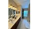 Bright bathroom features double sinks, walk-in shower, and window to let in lots of natural light at 10350 Lake District Ln # S, Orlando, FL 32832