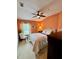 Comfortable bedroom featuring warm coral walls, soft lighting, and neutral toned furniture at 10350 Lake District Ln # S, Orlando, FL 32832