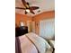 Comfortable bedroom features include a ceiling fan, closet, and beautiful furnishings at 10350 Lake District Ln # S, Orlando, FL 32832