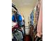 Walk-in closet boasts ample storage space with rods and shelving for clothes and accessories at 10350 Lake District Ln # S, Orlando, FL 32832