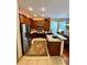 Well-lit kitchen featuring stainless steel appliances, granite countertops, and classic wood cabinetry at 10350 Lake District Ln # S, Orlando, FL 32832