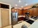 Efficient kitchen featuring stainless steel appliances and warm wood cabinetry at 10350 Lake District Ln # S, Orlando, FL 32832