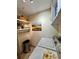 Cozy laundry room with storage shelves, washer, dryer, and decorative wall art at 10350 Lake District Ln # S, Orlando, FL 32832