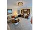 Comfortable living room with neutral tones, a decorative light fixture, and cozy armchairs at 10350 Lake District Ln # S, Orlando, FL 32832