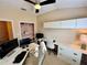 Home office featuring a large desk, ample storage, a ceiling fan, and a closet for organization at 10350 Lake District Ln # S, Orlando, FL 32832