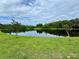 Scenic pond with clear reflections, surrounded by lush greenery and picturesque landscaping at 10350 Lake District Ln # S, Orlando, FL 32832