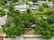 Aerial shot of the property showcasing the surrounding neighborhood and mature trees at 1046 Seminole Creek Dr, Oviedo, FL 32765