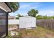 Backyard showing a storage shed with white fencing and some tree coverage at 1046 Seminole Creek Dr, Oviedo, FL 32765