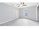 Bedroom features neutral walls, sleek floors, ceiling fan and a bright window at 1046 Seminole Creek Dr, Oviedo, FL 32765