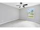 Cozy bedroom featuring neutral paint, sleek floors, ceiling fan, and window view at 1046 Seminole Creek Dr, Oviedo, FL 32765
