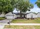 Charming single-story home with a basketball hoop, mature tree, and well-maintained front yard at 1046 Seminole Creek Dr, Oviedo, FL 32765