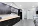 Well-lit kitchen with dark cabinetry, wood counters, stainless appliances and easy access to next room at 1046 Seminole Creek Dr, Oviedo, FL 32765