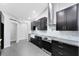 Contemporary kitchen with dark cabinets, stone countertops, and stainless steel appliances at 1046 Seminole Creek Dr, Oviedo, FL 32765