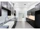 Modern kitchen with dark cabinets, stainless steel appliances, and an open layout at 1046 Seminole Creek Dr, Oviedo, FL 32765