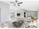 Living room showcasing vaulted ceilings, fan, and seamless flow into the dining area with contemporary decor at 1046 Seminole Creek Dr, Oviedo, FL 32765