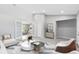 Bright living room with white french doors and neutral furniture arrangement on chevron-patterned rug at 1046 Seminole Creek Dr, Oviedo, FL 32765