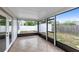 Enclosed back porch with a tile floor and views of the backyard and storage shed at 1046 Seminole Creek Dr, Oviedo, FL 32765