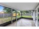 Enclosed back porch with large windows offering views of the backyard and tiled floor at 1046 Seminole Creek Dr, Oviedo, FL 32765