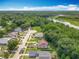 An aerial view showcases the neighborhood's serene location near lush green forests and a beautiful river at 10460 Riva Ridge Trl, Orlando, FL 32817