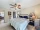 Comfortable bedroom features tile flooring, ceiling fan, and soothing wall color at 10460 Riva Ridge Trl, Orlando, FL 32817