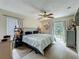 Bright bedroom with a ceiling fan, tile floors, and sliding glass doors to the backyard at 10460 Riva Ridge Trl, Orlando, FL 32817