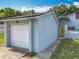 Exterior showing attached garage and entrance with well-maintained landscaping at 10460 Riva Ridge Trl, Orlando, FL 32817