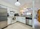 Kitchen featuring white cabinets, stainless appliances, granite counters and open floor plan at 10460 Riva Ridge Trl, Orlando, FL 32817