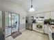 Bright kitchen with stainless steel appliances, white cabinets, tile flooring and a breakfast nook at 10460 Riva Ridge Trl, Orlando, FL 32817