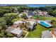 Aerial view of condo community, lush landscaping, pool, and lake views at 1051 S Highland St # 5E, Mount Dora, FL 32757