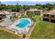 Aerial view of complex shows a pool, well-maintained condos and lush green lawns and gardens at 1051 S Highland St # 5E, Mount Dora, FL 32757